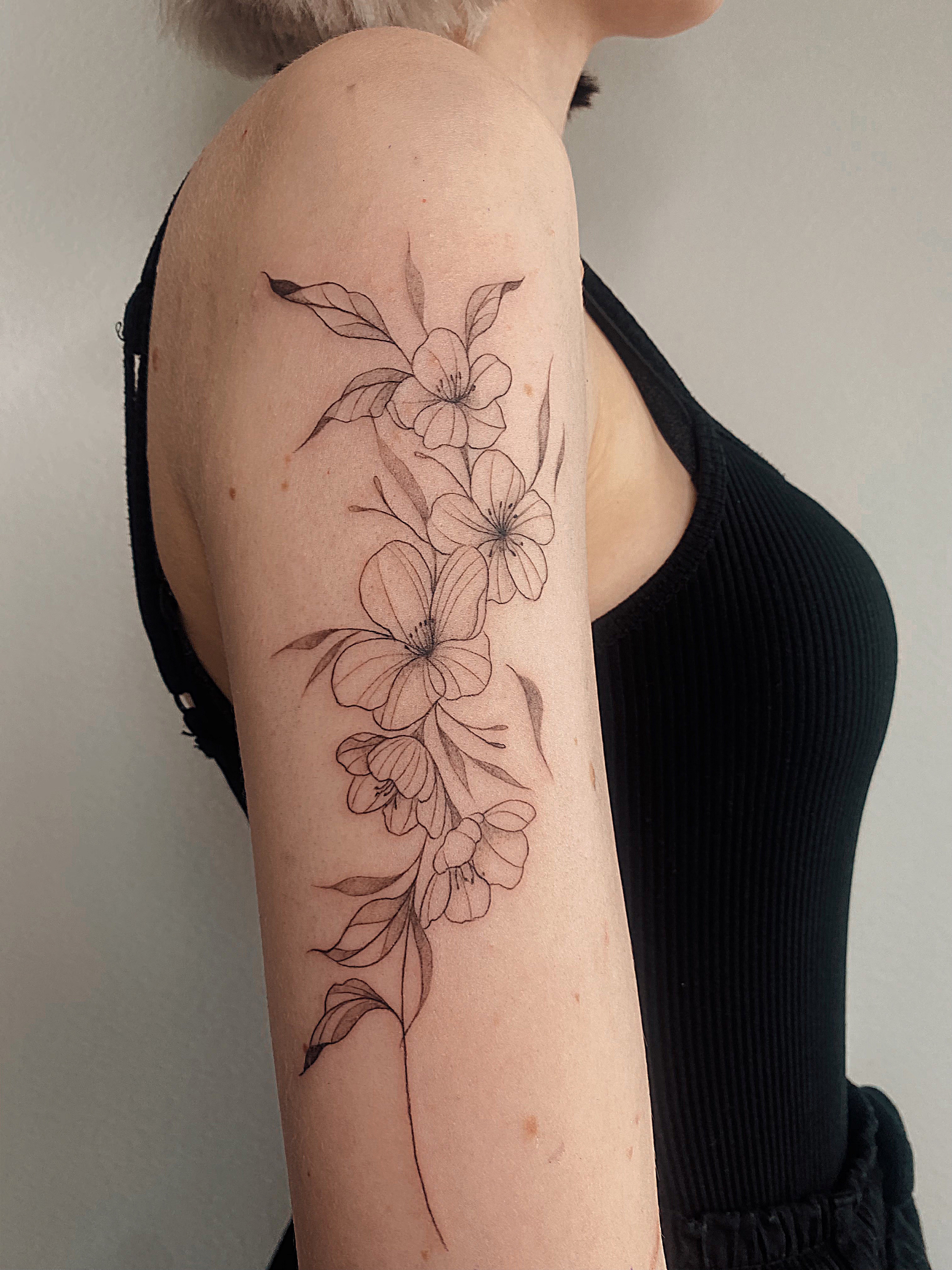 Helsinki-tattoo-Mayink-realistic-floral-bough-arm-scaled.jpg