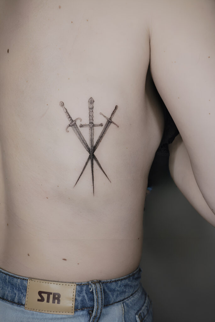 Tattoo-Helsinki-Realistic-Minirealism-3-swords-side-scaled.jpeg