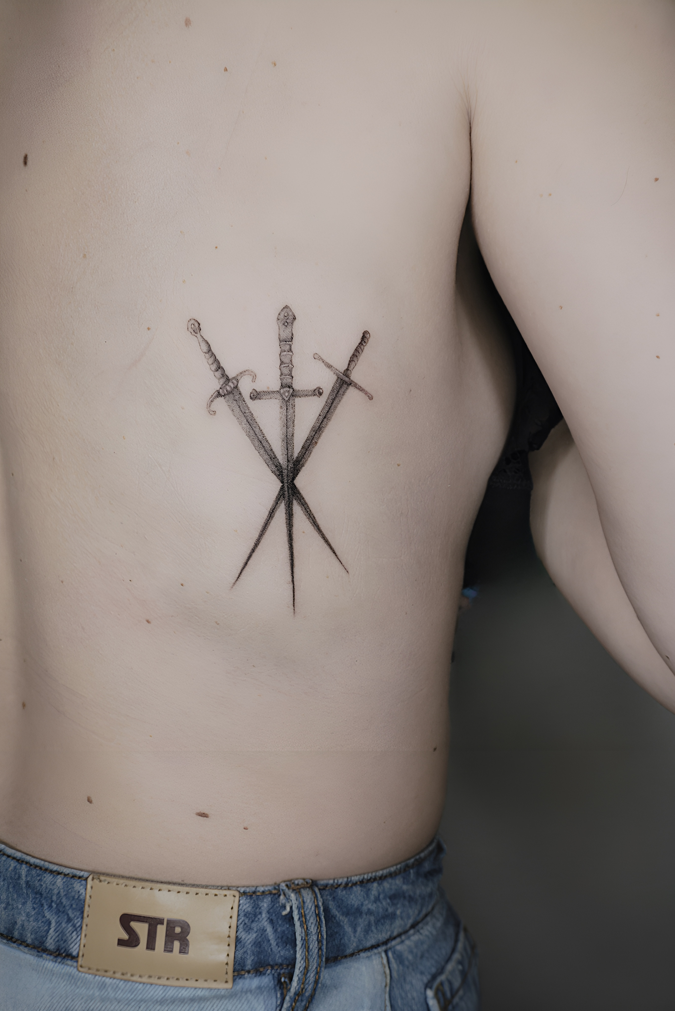 Tattoo-Helsinki-Realistic-Minirealism-3-swords-side-scaled.jpeg