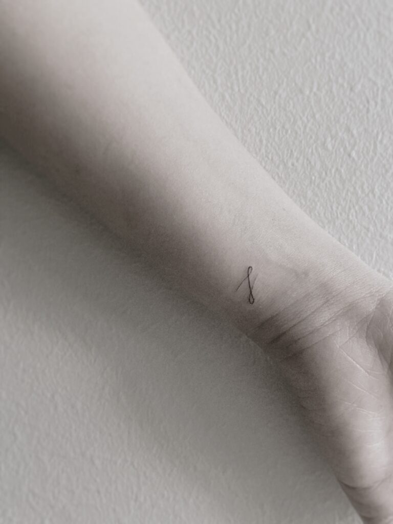 Tattoo-Helsinki-text-line-textwork-wrist-scaled.jpg