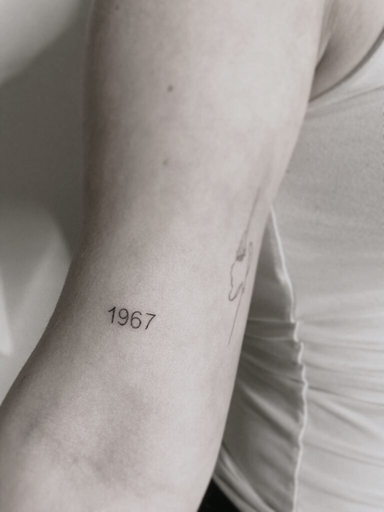 Tattoo-Helsinki-text-line-textwork-yaer-1967-scaled.jpg