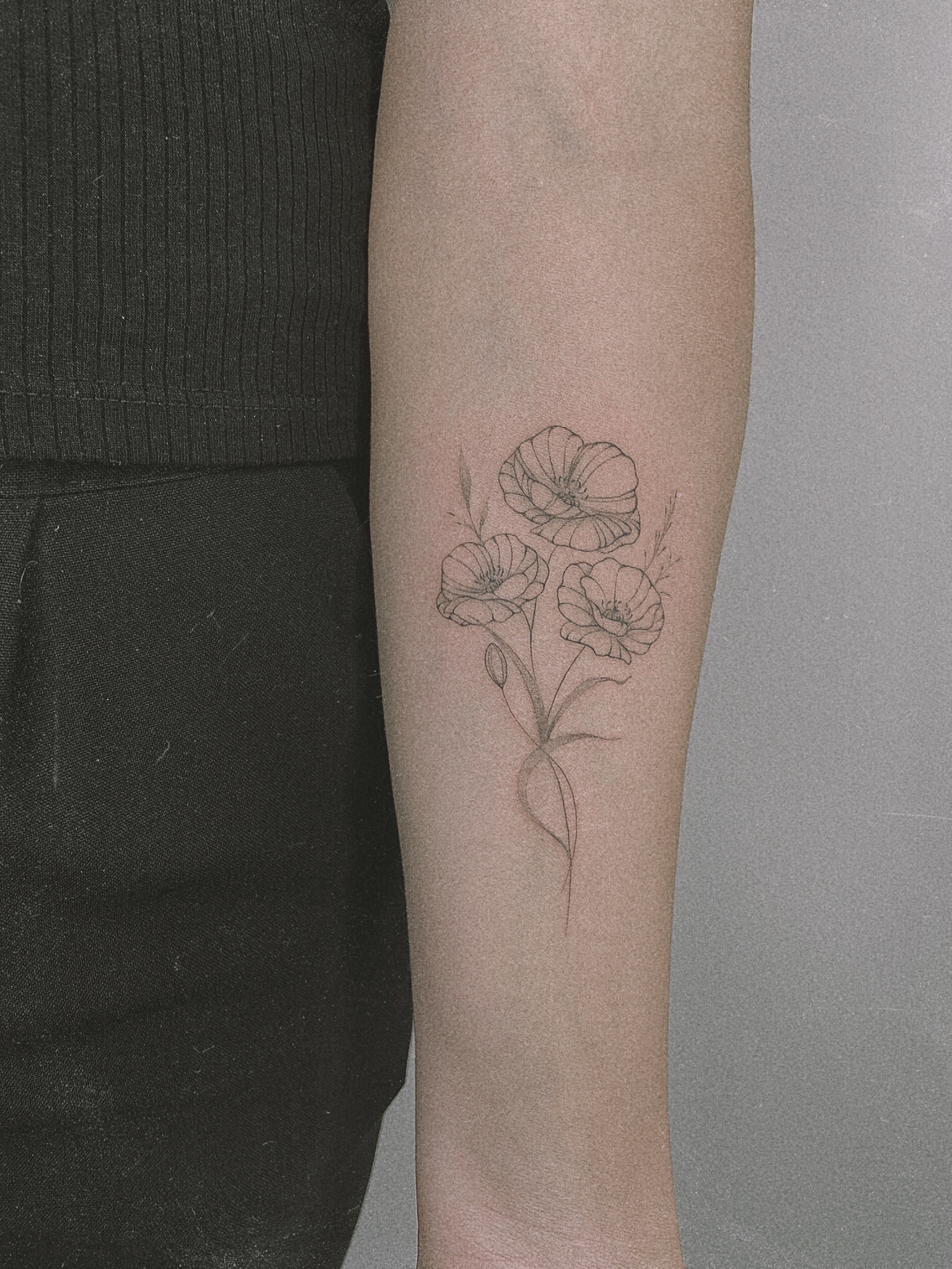 Fine line floral tattoo