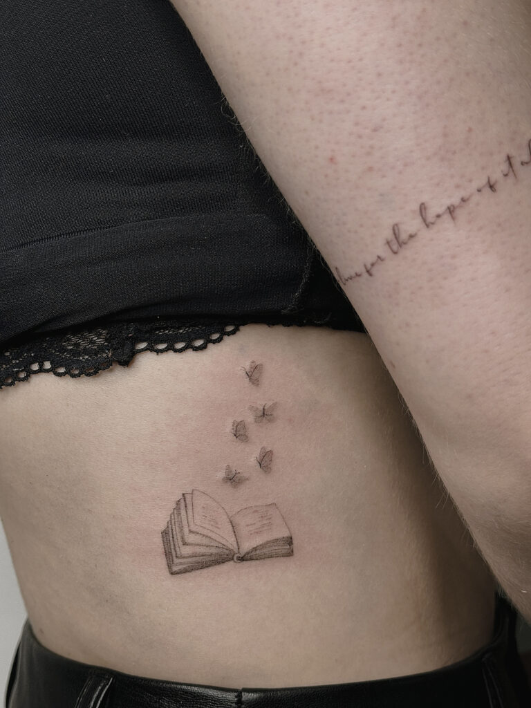 tattoohelsinki-book-and-butterflies-tattoo-realism-tattoo-scaled.jpg